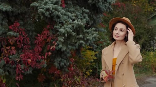 Elegant Woman in Autumn Nature Scene