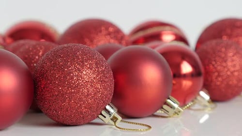 Shiny red baubles Christmas holiday decoration slow tilt 4K video