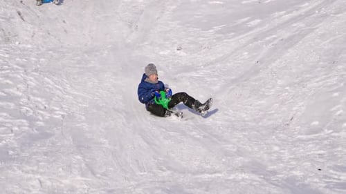 Frost winter season. Two children ride down a hill, winter games and fun.