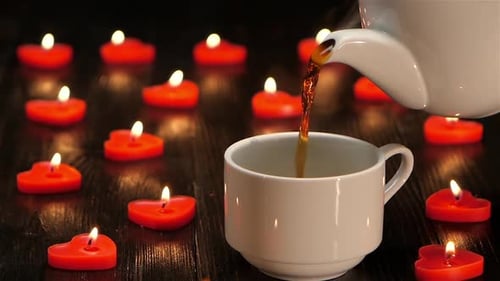 Pouring Tea by Heart Candles for Romantic Mood