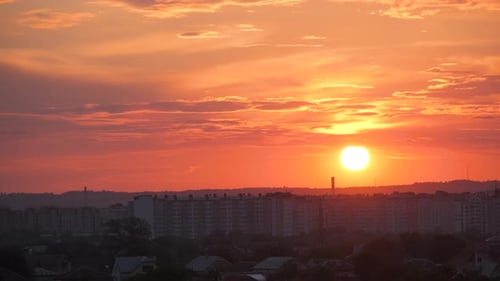 Colorful Evening Landscape with Soft Pastel Coloured Clouds Over Dark Distant Cityscape with