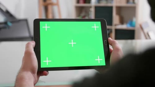 Man Hold Horizontally a Tablet with Green Screen on
