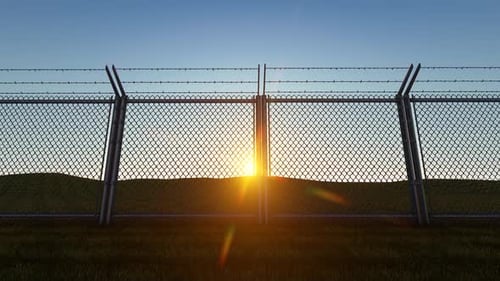 Chain Link Fence and Barbed Wire at Sunrise or Sunset Animation