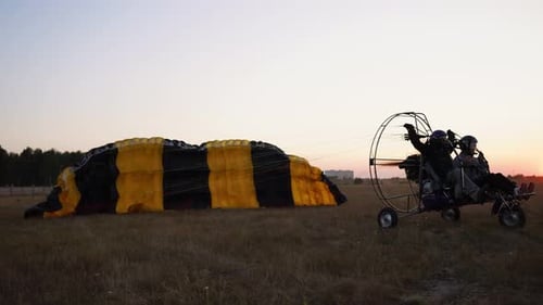 Motor Paraglider Takes Off with a Girl and a Man at the Airport Accelerating and Taking Off