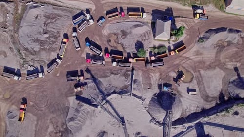 Excavator Loading Crushed Stone Into a Dump Truck in a Crushed Stone Quarry