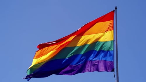 Rainbow Pride Flag Waving Proudly in the Sky