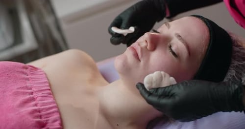 Cosmetologist Cleans a Woman's Face with Sponges Face Care at the Beauty Salon 60p Prores HQ