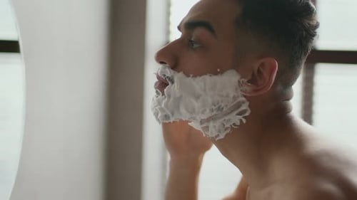 Man Applies Shaving Cream to his Face