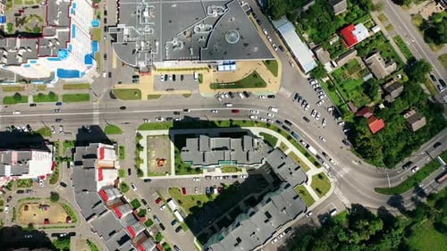 Modern cityscape. Residential streets and cars between apartment building rooftops.