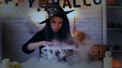 Woman Witch Brews Potion for Halloween Party