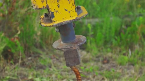 Screwing a Metal Pile Into the Ground