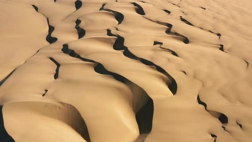 Aerial Top Down on the Desert Nature. Incredible Waving Texture of Sand Dunes
