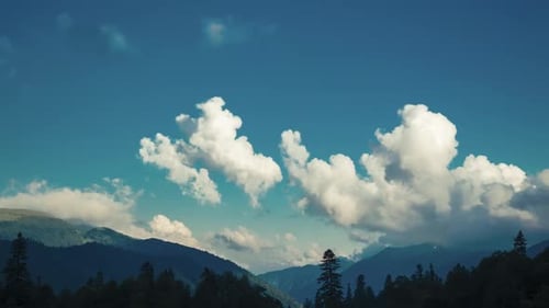 Accelerated Shooting From the Place of Large Moving Clouds Shading Mountain Hills, Forests and