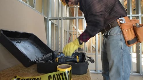 Caucasian Construction Worker Preparing His Tools For the Job