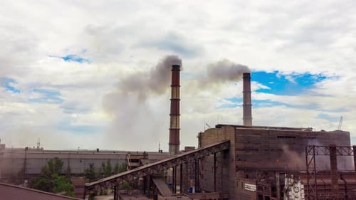 Industrial Complex with Smokestacks Emitting Smoke Aerial Shot