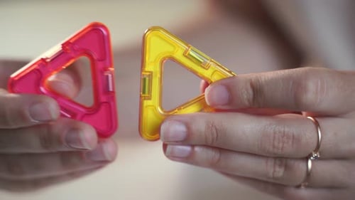 Close Up of Magnetic Building Toy. WOman Playing with Preschooler.