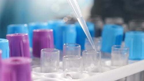 Liquid Being Poured Into Test Tubes