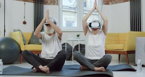 Senior Couple Meditating with VR Headsets at Home