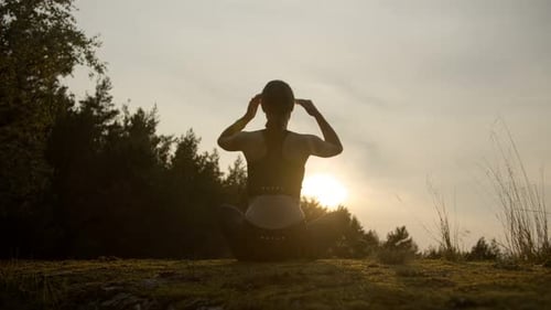 Woman Meditating Outdoors at Sunrise