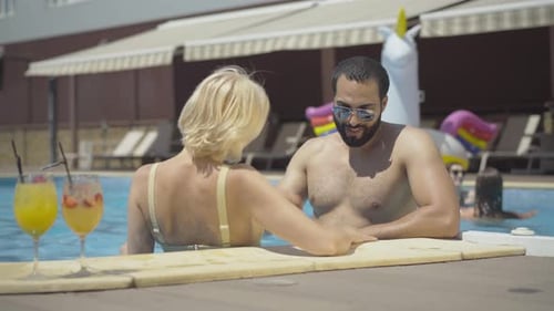 Couple Enjoying Poolside Fun on Summer Vacation