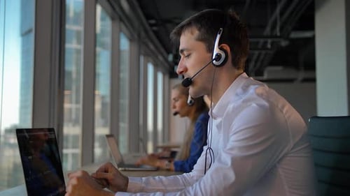 Handsome Businessman Entrepreneur in Headset Calling To Cuctomers in Business Office Call Center