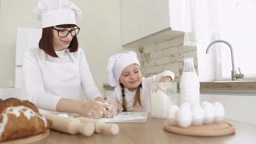 Charming Adorable Attractive Beautiful Caucasian Sprinkle Flour on the Dough While Smiling to Young