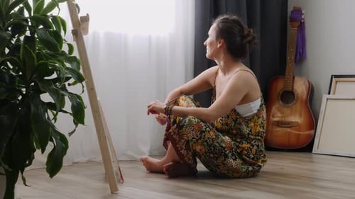 Woman Artist Painting on Easel at Home