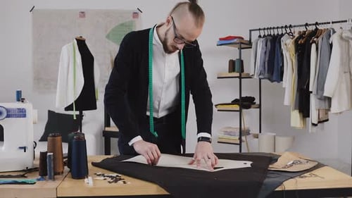 Young Adult Fashion Designer Working in Studio