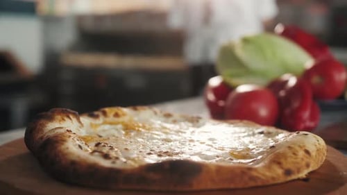Grated Cheese Being Added to Pizza