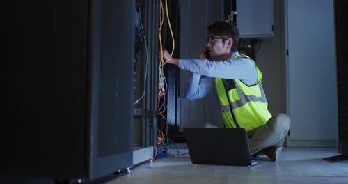 Technician Working on Servers while Talking on Phone