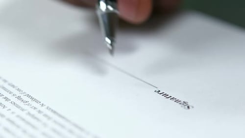 Close Up of Pen Signing Document