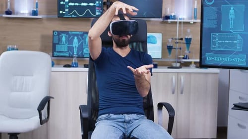 Young Male Sitting on a Chiar in a Modern Brain Laboratory