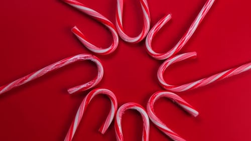 Festive Candy Canes Arranged on a Red Background