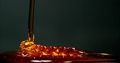 Honey Flowing against Black Background, Slow Motion 4K
