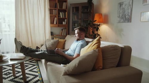 Man Using Laptop Computer in Living Room