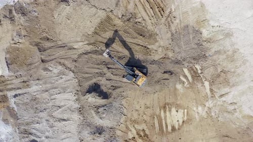 Excavator Digging in Field Aerial View