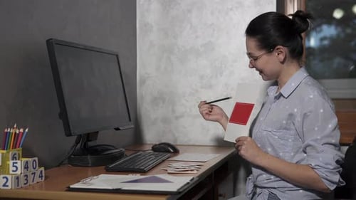 Woman Teaching Shapes and Numbers Using Flashcards