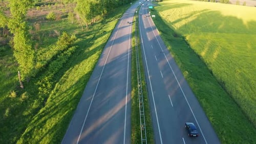 Aerial View of the Highway Among Green Fields in Spring
