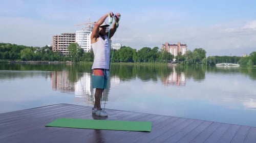 Man Exercising Arms with Resistance Band on Dock