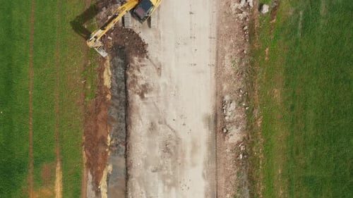 Aerial View of Yellow Bulldozer Collects Soil in the Field