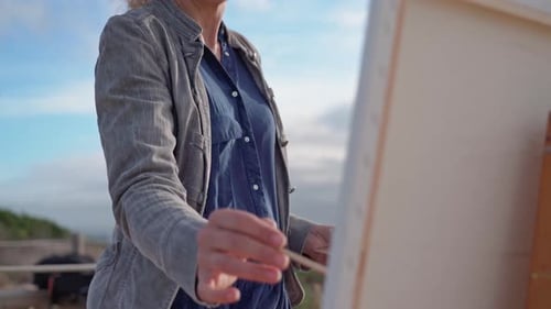 Woman Painting Outdoors on a Sunny Day