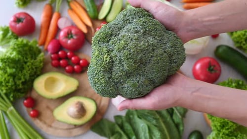 Broccoli In Hands. Healthy Eating Concept.