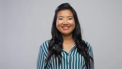 Woman Smiling and Laughing on Grey Background