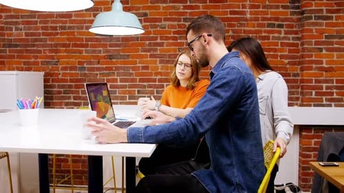 Business Colleagues Collaborating Around Table in Modern Office