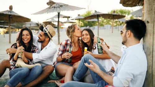 Happy People Drinking and Having Fun at Beach