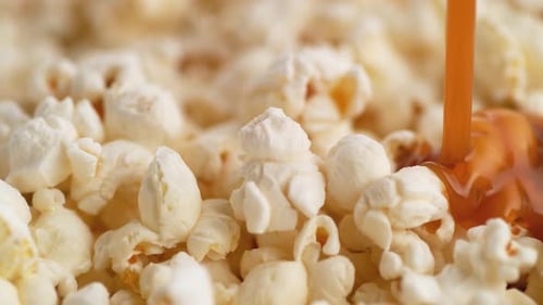 Caramel Being Poured Over Fresh, White Popcorn