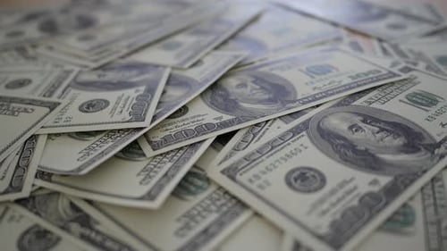 Slow motion of Counting dollar banknote money on table
