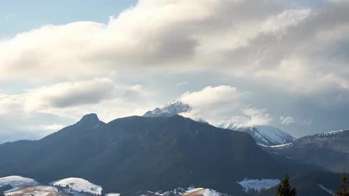 Clouds Spill Over the Mountain Alpine Peaks