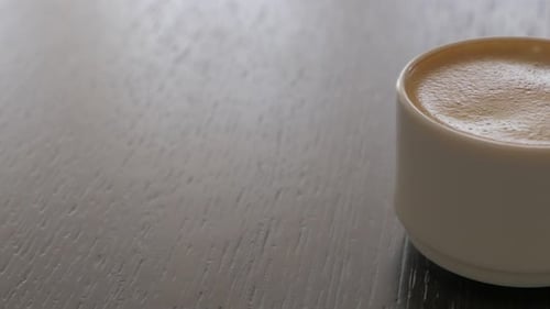 Close Up of Coffee Cup on Wooden Table