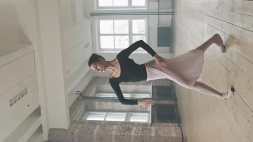 Ballerina Practices Graceful Ballet Dance in Studio